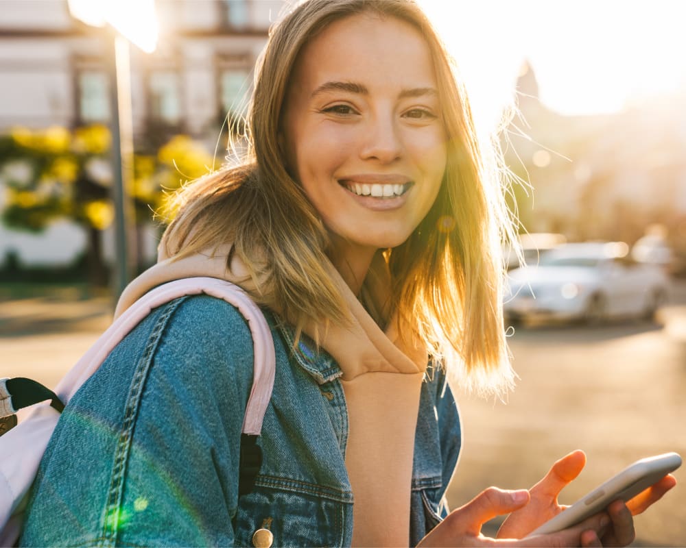 A diverse group of teenagers smile for the camera, showing off bright white teeth that are straight.