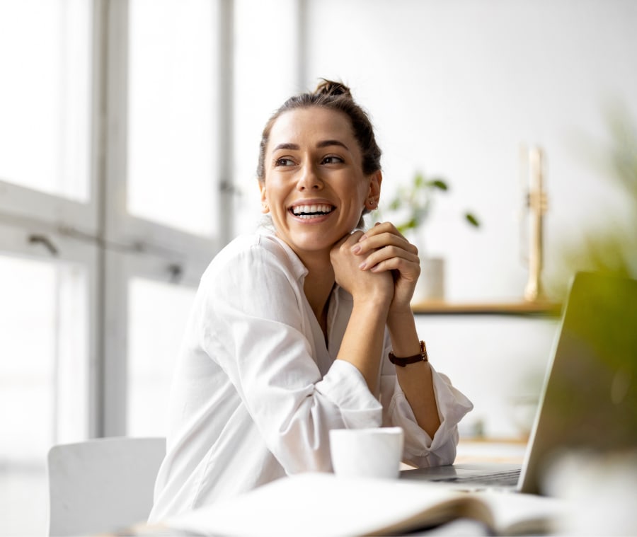 Smiling woman with smooth wrinkle-free skin smiling at someone to her right.