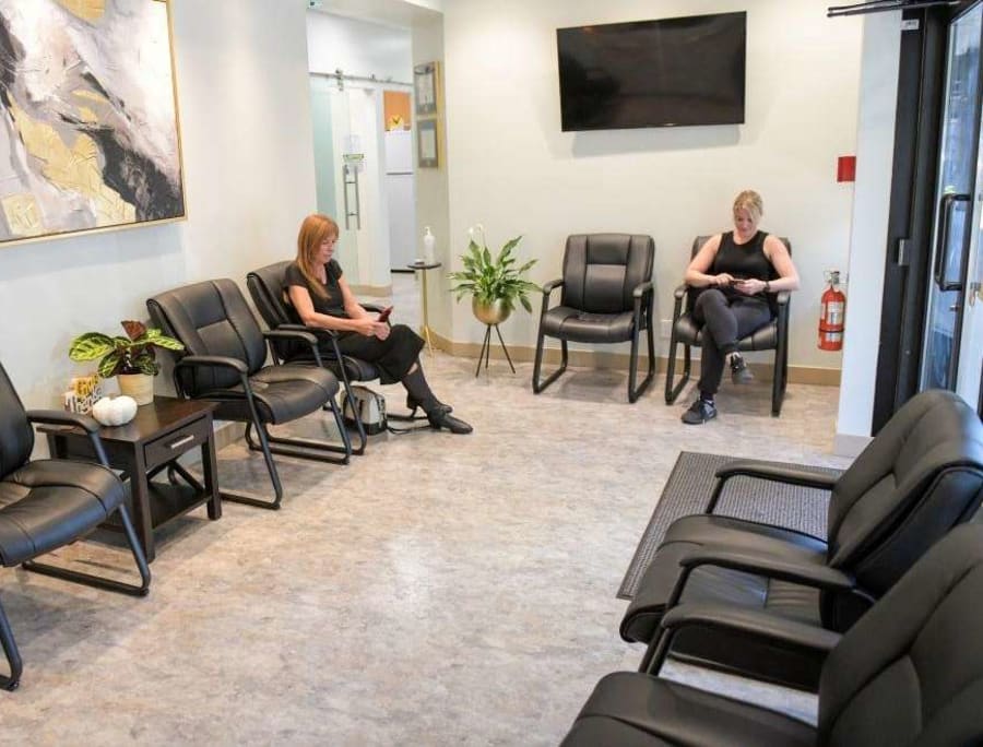 Two women sitting in the Hunter & King Dentistry waiting room.